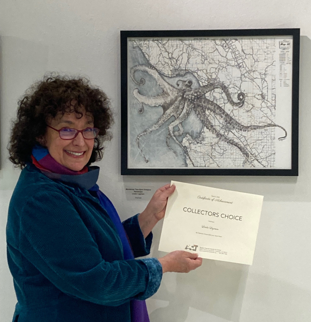 Linda Legman stands in front of her octopus drawing.